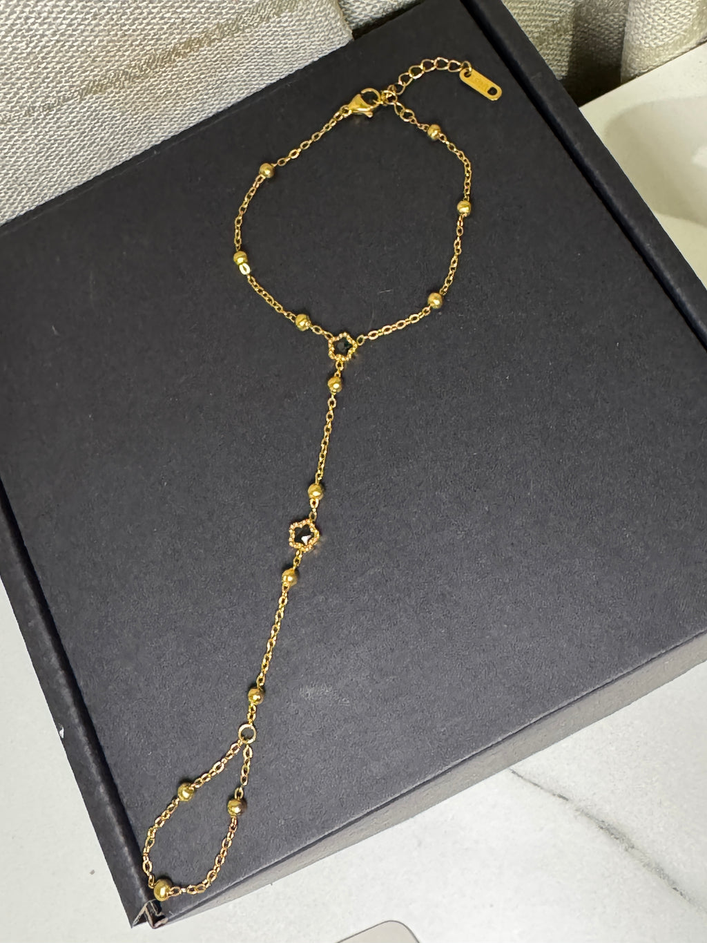 Golden Lily – Hand Chain Noir Blossom