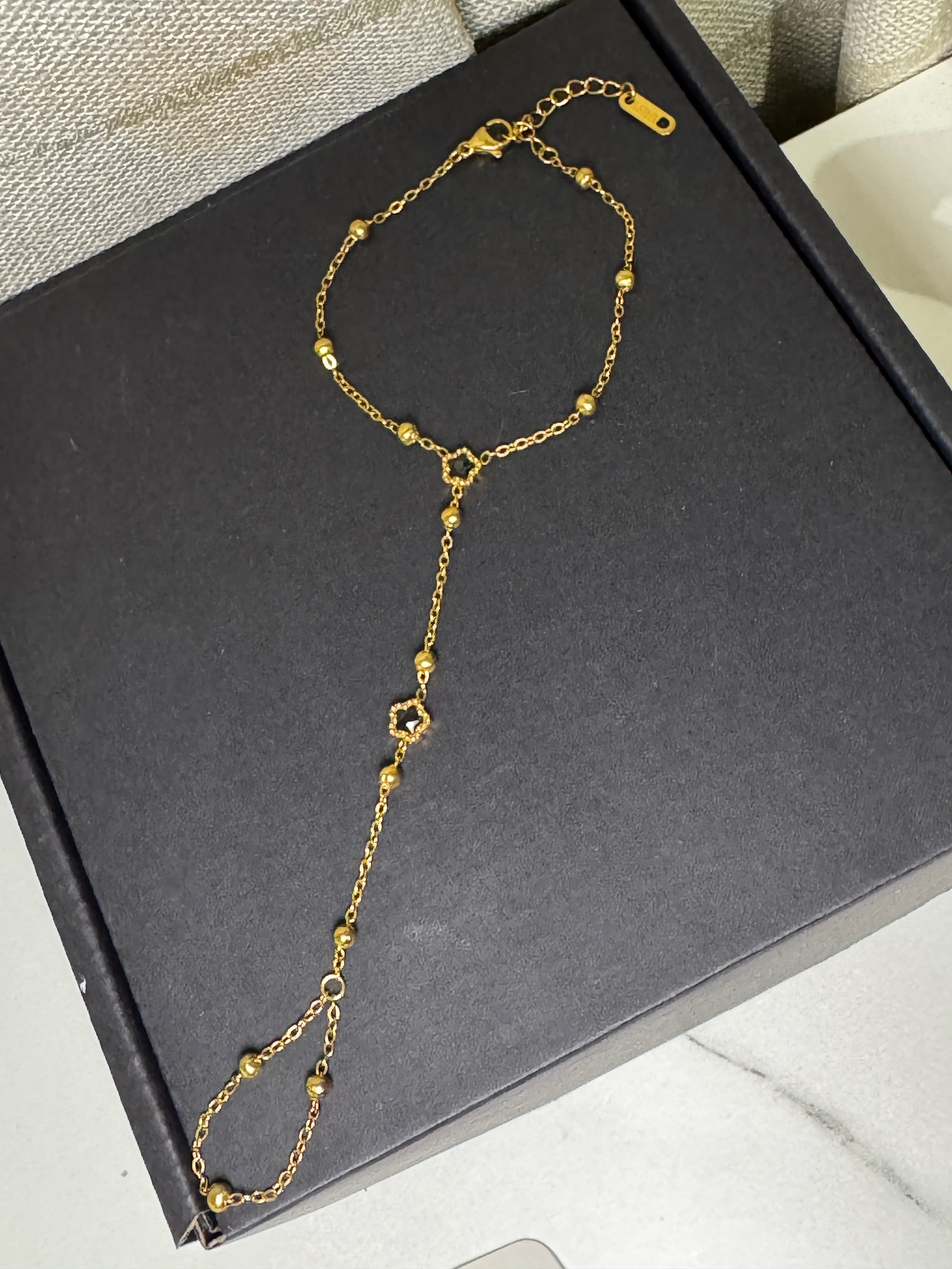 Golden Lily – Hand Chain Noir Blossom